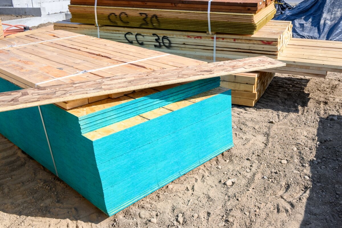 Stos sklejki wodoodpornej na placu budowy.